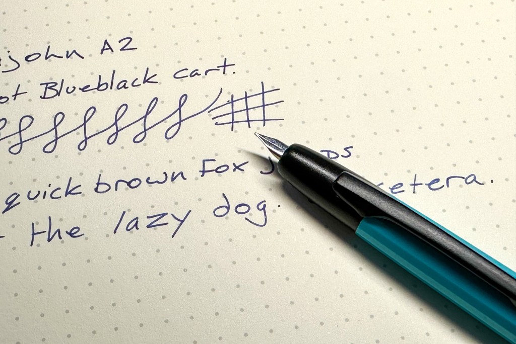 Majohn A2 fountain pen in aqua blue with a writing sample