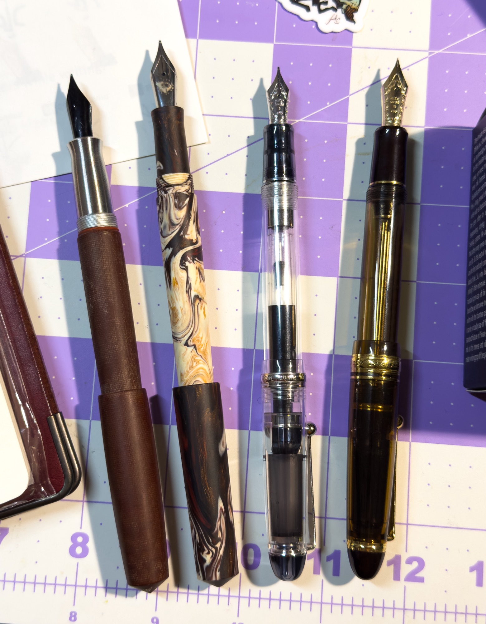 Fountain Pen Lineup from CAPS on a 1 inch grid background