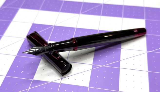 Monteverde Impressa with the cap off on a 1 inch grid background