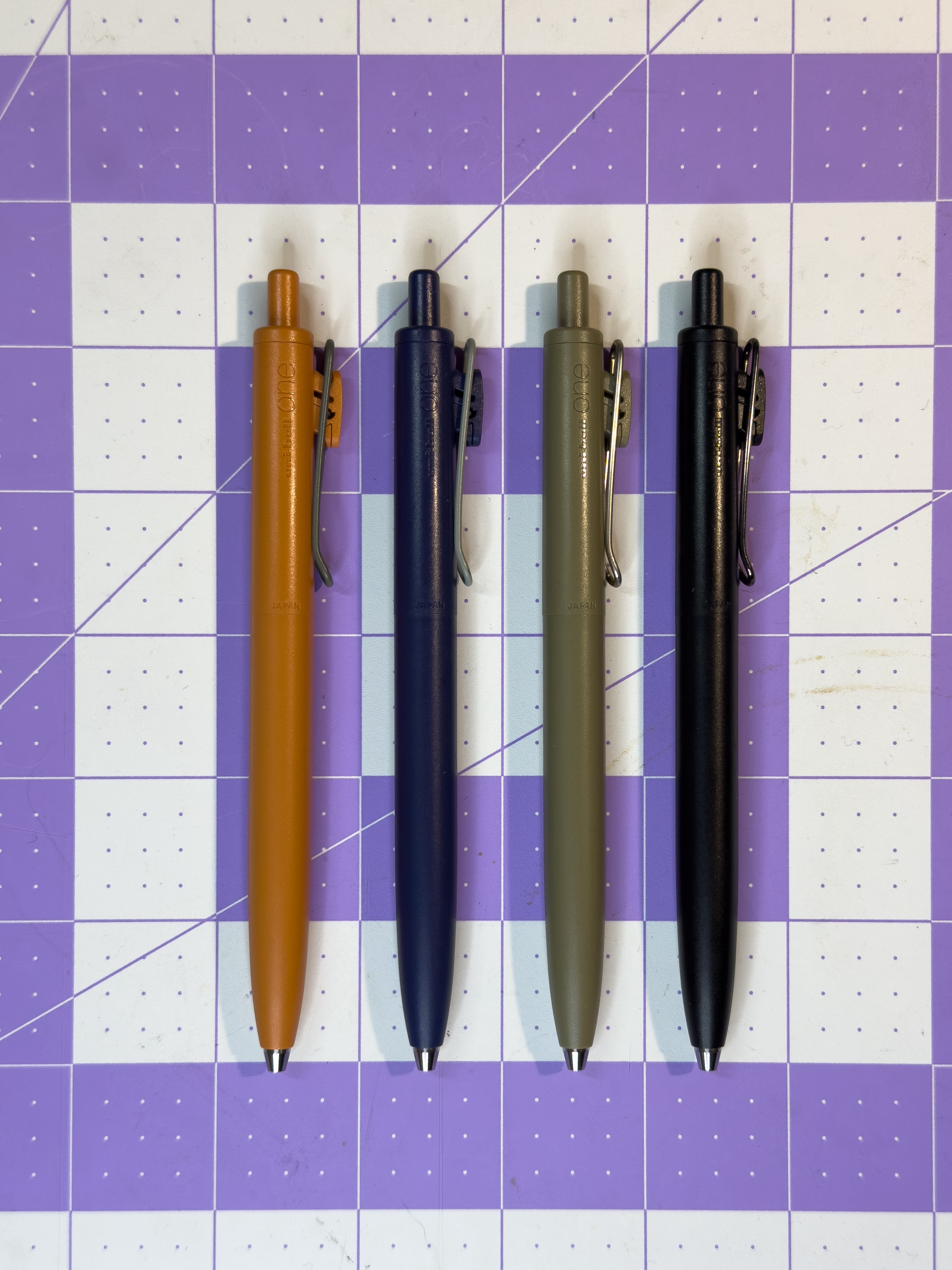 Uni-Ball One F pens in a lineup, showing multiple barrel colors